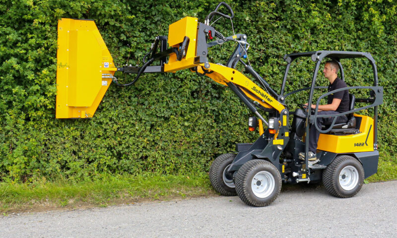 1422 SGT compact wheel loader trimming bushes